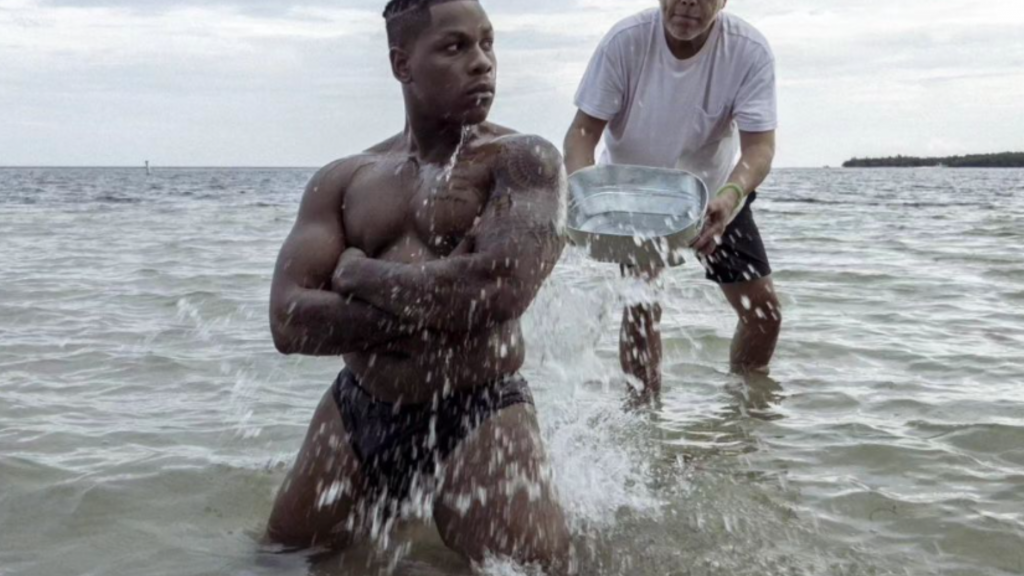 John Boyega in a speedo on the beach,